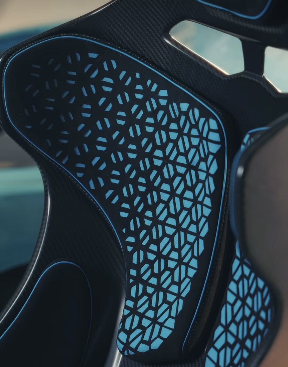 Laser-cut hexagon pattern on a seat backrest, close-up