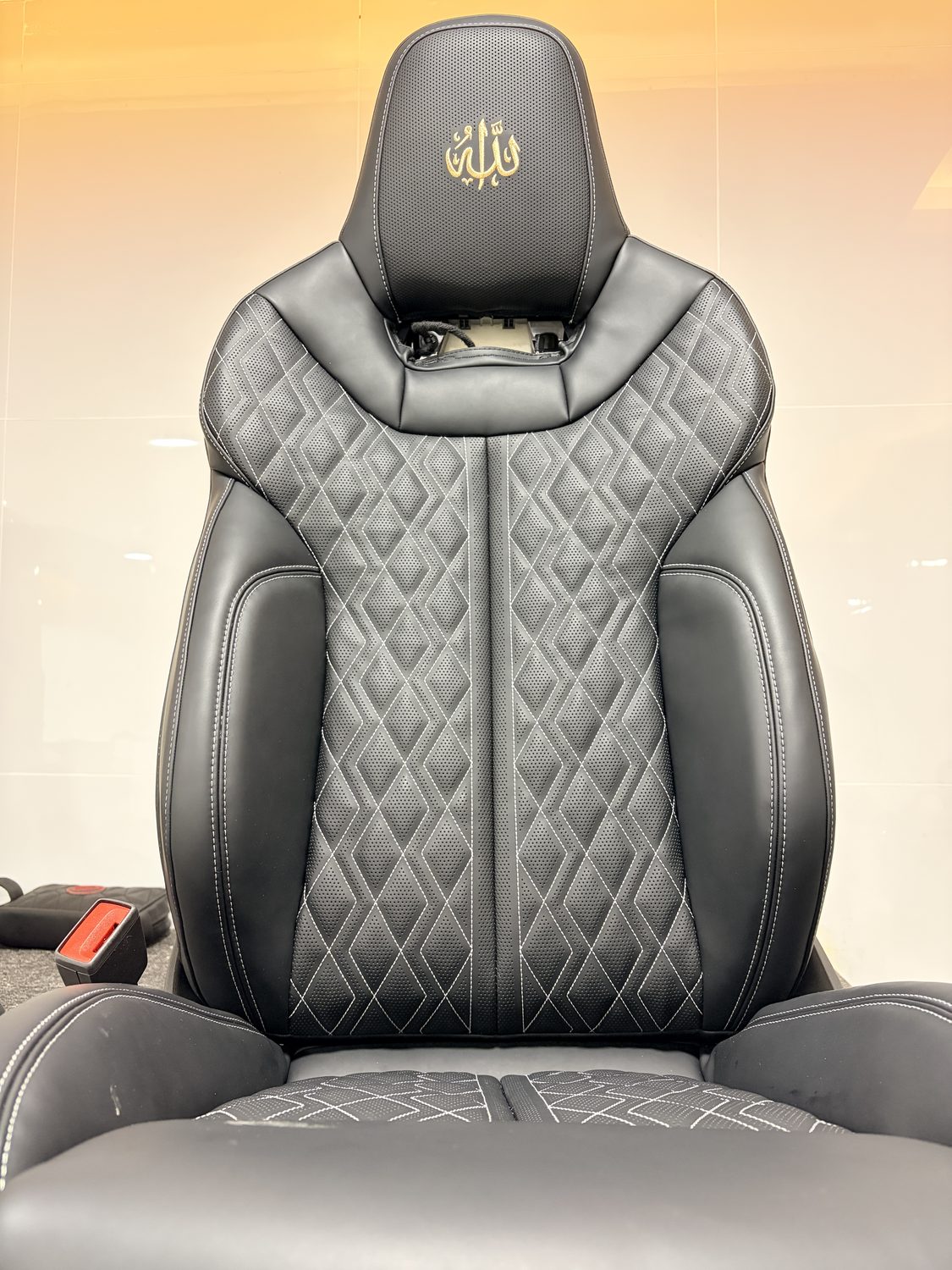 Diamond-quilted black leather seat with perforated panels