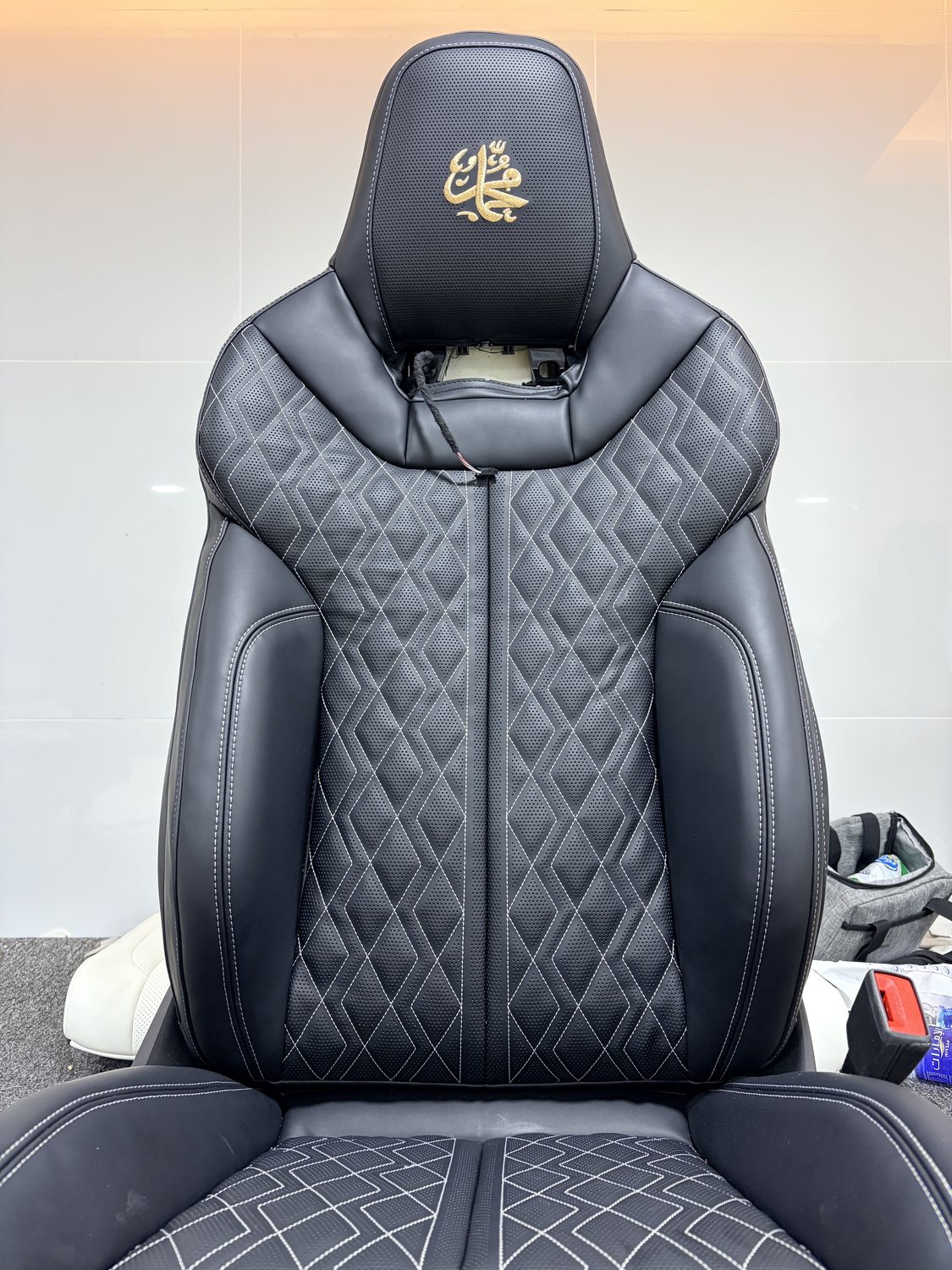 Diamond-quilted leather seat with an embroidered headrest emblem